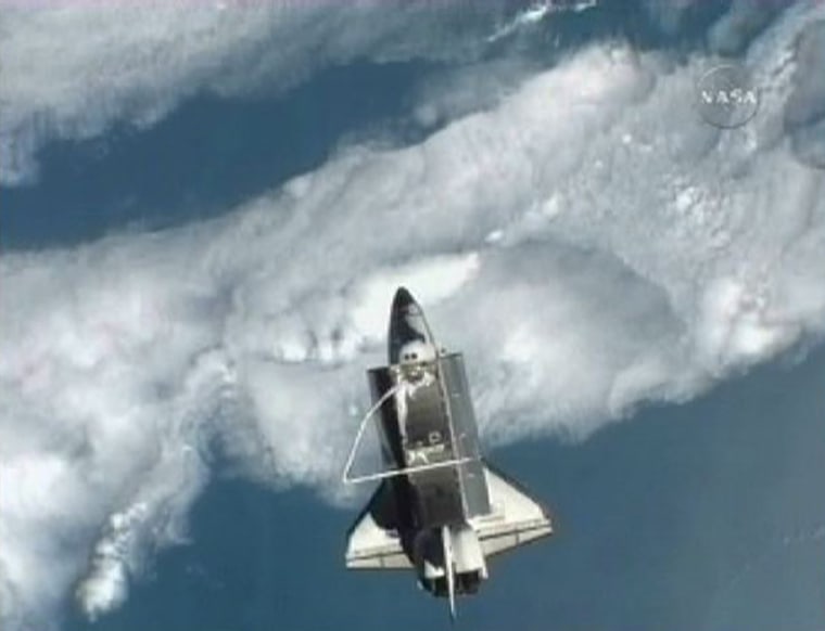 Image: Image taken from NASA TV shows Space shuttle Atlantis pictured against the Earth